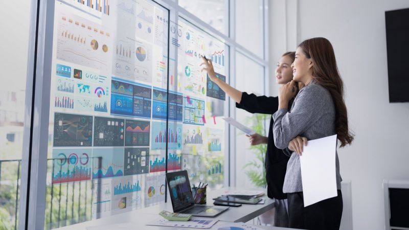 Analysts working at a data visualisation wall